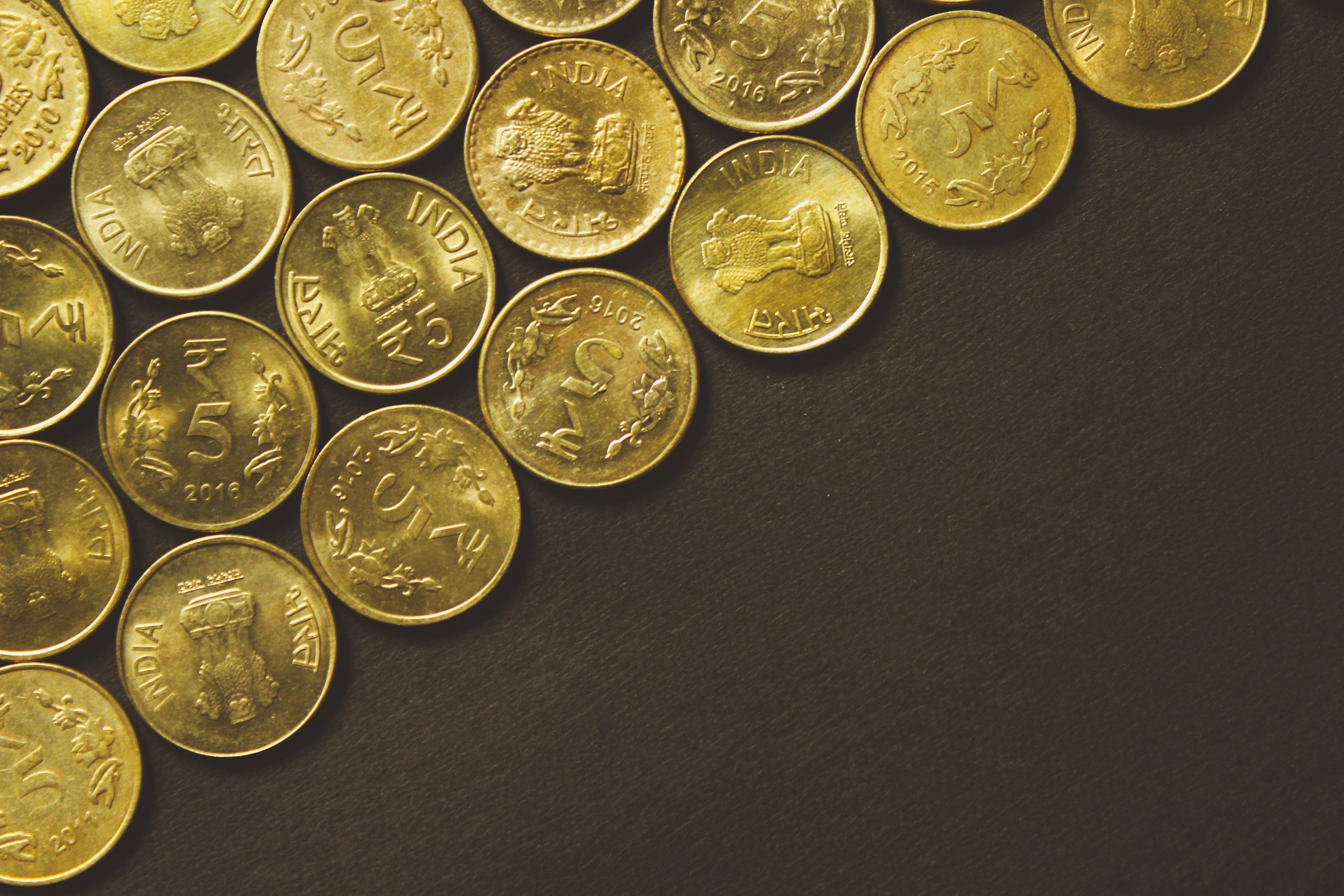 spread out gold coins on a table