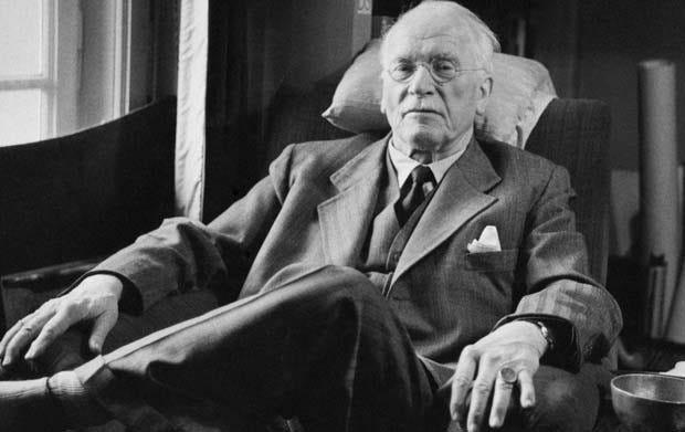 Carl Jung relaxing in a chair in black and white