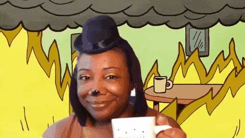 Gif of Patricia as the "this is fine" meme. The gif is 12 seconds long. She is in a room with animated flames and she takes a sip from white mug.
