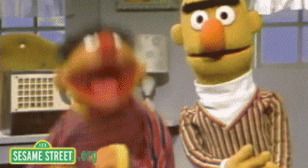 Ernie is jumping up and down and Bert looks skeptical but then starts jumping too.