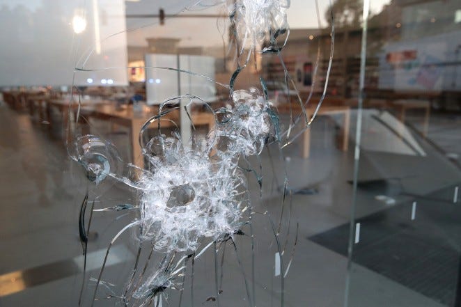 A broken storefront window is seen after parts of the city had widespread looting and vandalism in Chicago