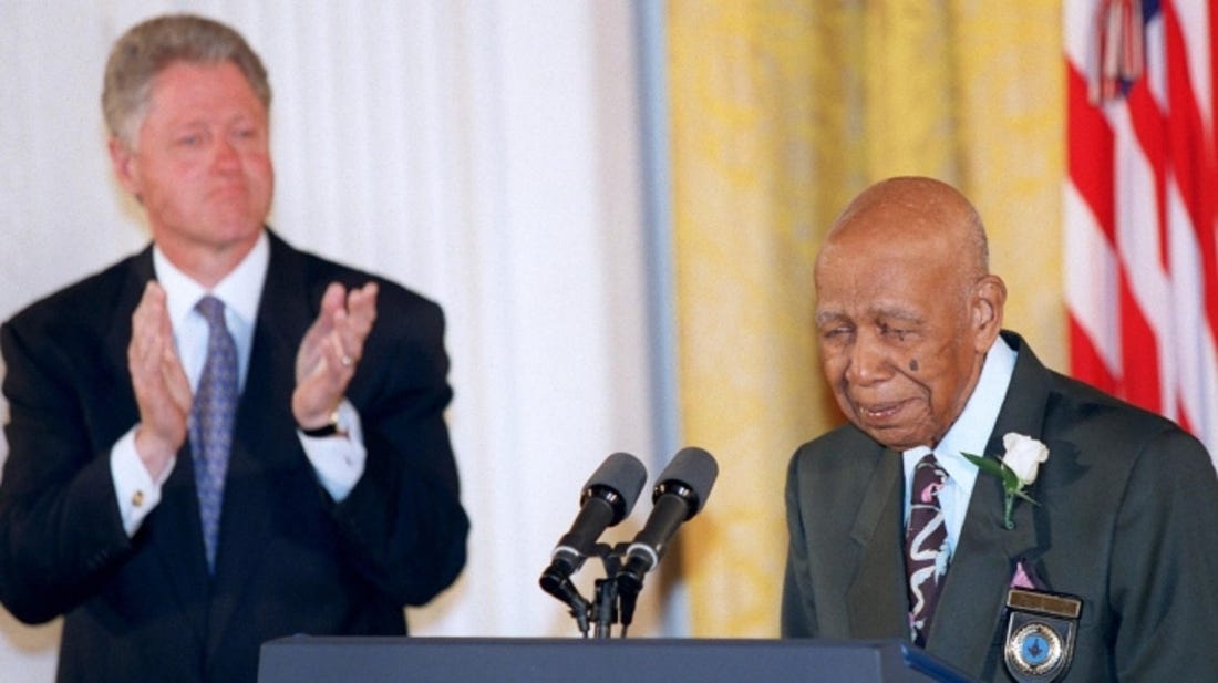 Herman Shaw speaks as President Bill Clinton looks on during ceremonies at the White House on May 16, 1997, during which Clinton apologized to the survivors and families of the victims of the Tuskegee Syphilis Study.