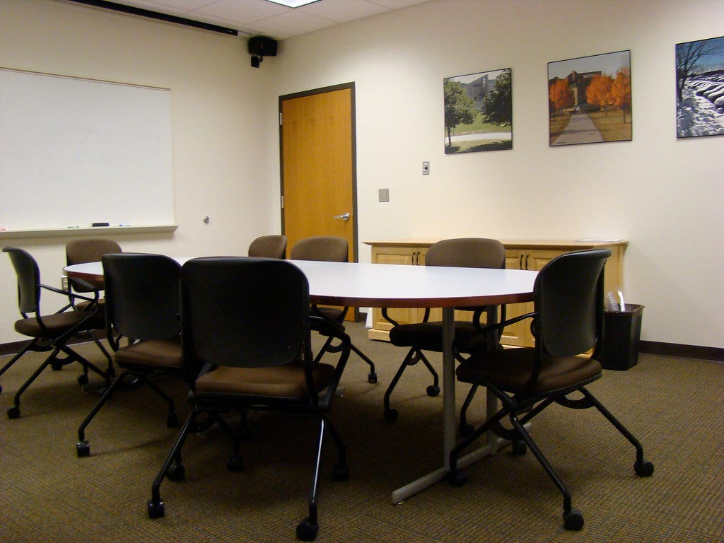 Meeting table in conference room and whiteboard