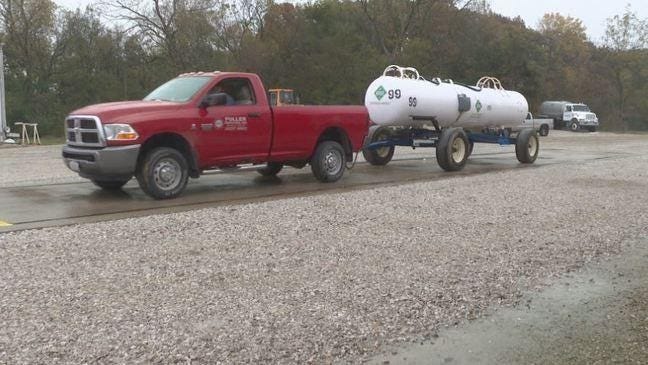 A pick-up truck hauls a tank of anhydrous ammonia gas.