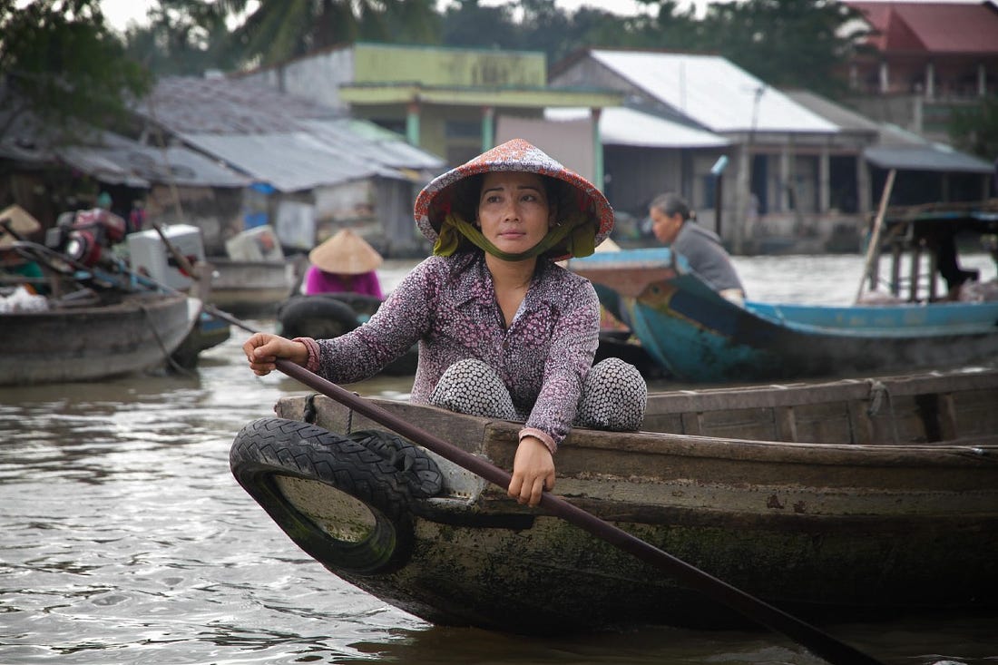 woman paddling on boat in Can Tho, Vietnam