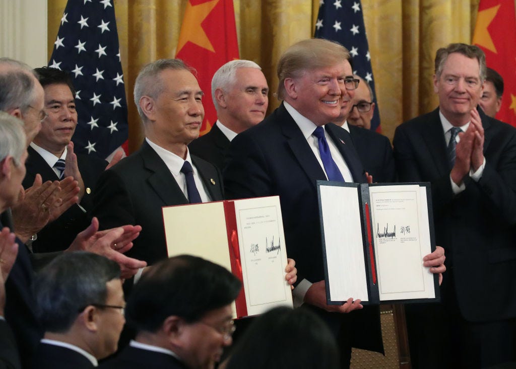 resident Donald Trump and Chinese Vice Premier Liu He, hold up signed agreements of phase 1 of a trade deal between the U.S. and China, in the East Room at the White House, on January 15, 2020 in Washington, DC. Phase 1 is expected to cut tariffs and promote Chinese purchases of U.S. farm, and manufactured goods while addressing disputes over intellectual property. (Photo by Mark Wilson/Getty Images) resident Donald Trump and Chinese Vice Premier Liu He, hold up signed agreements of phase 1 of a trade deal between the U.S. and China, in the East Room at the White House, on January 15, 2020 in Washington, DC. Phase 1 is expected to cut tariffs and promote Chinese purchases of U.S. farm, and manufactured goods while addressing disputes over intellectual property. (Photo by Mark Wilson/Getty Images)