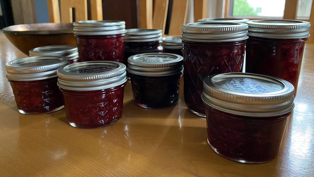 Eleven mason jars of strawberry jam