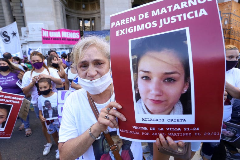 A demonstrator holds a sign reading, 'Stop killing us, we demand justice', during a protest against violence towards women, in Buenos Aires, Argentina [Flor Guzzetti/Reuters]