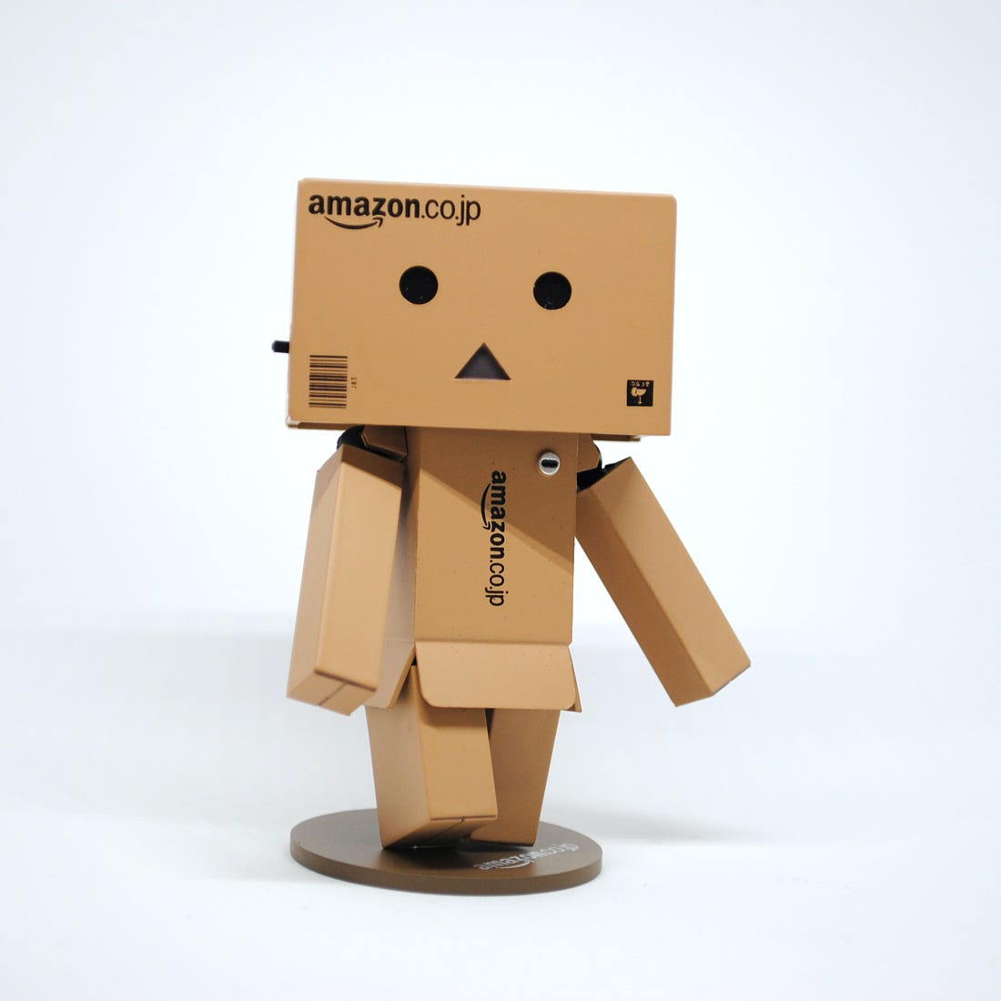 Photo of a man made out of Amazon-branded cardboard boxes. Unsplash