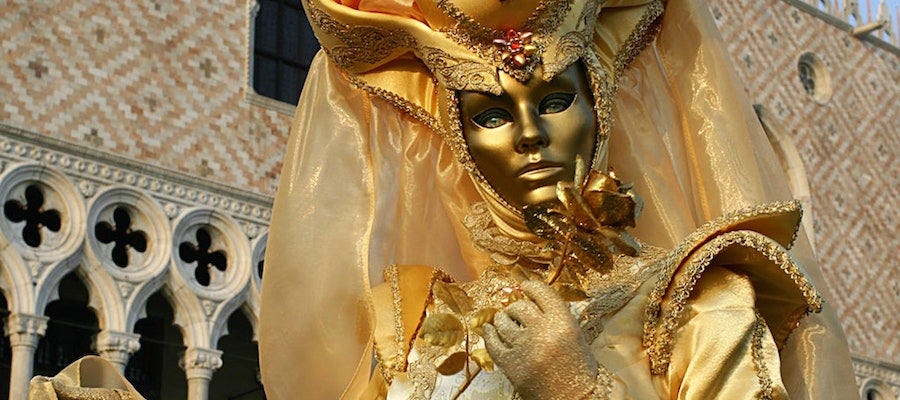 Person wearing golden mask