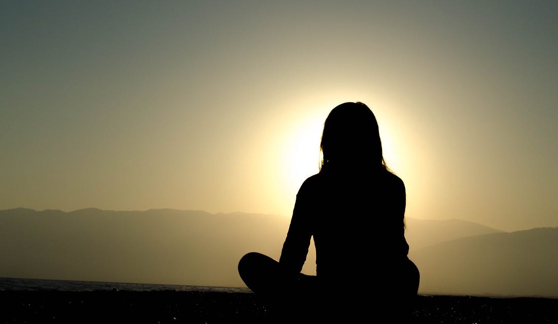 Image of a silhouette of a girl against the setting sun for article titled “why creativity flourishes in solitude” on medium