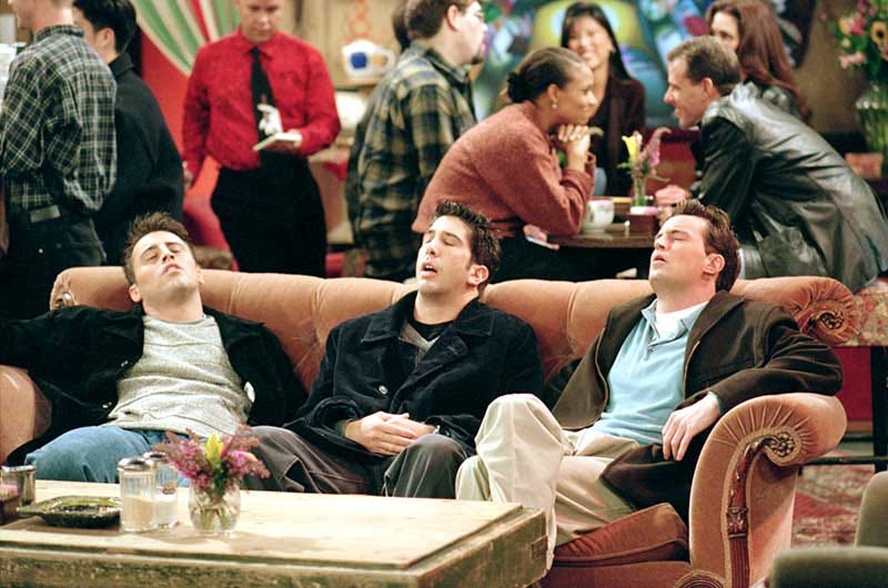 Matt LeBlanc as Joey, David Schwimmer as Ross, and Matthew Perry as Chandler, sitting on couch with eyes closed, in Central Perk coffee house from episode “The One Where They're Going To Party”.