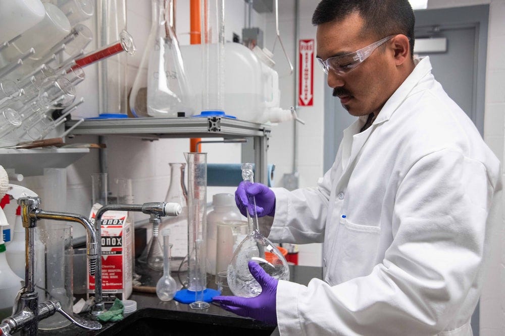 man mixing a flask inside a laboratory