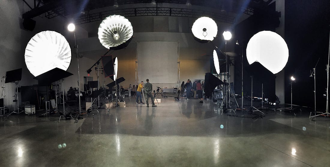 Behind the scenes production photo with 4 large parabolic umbrellas