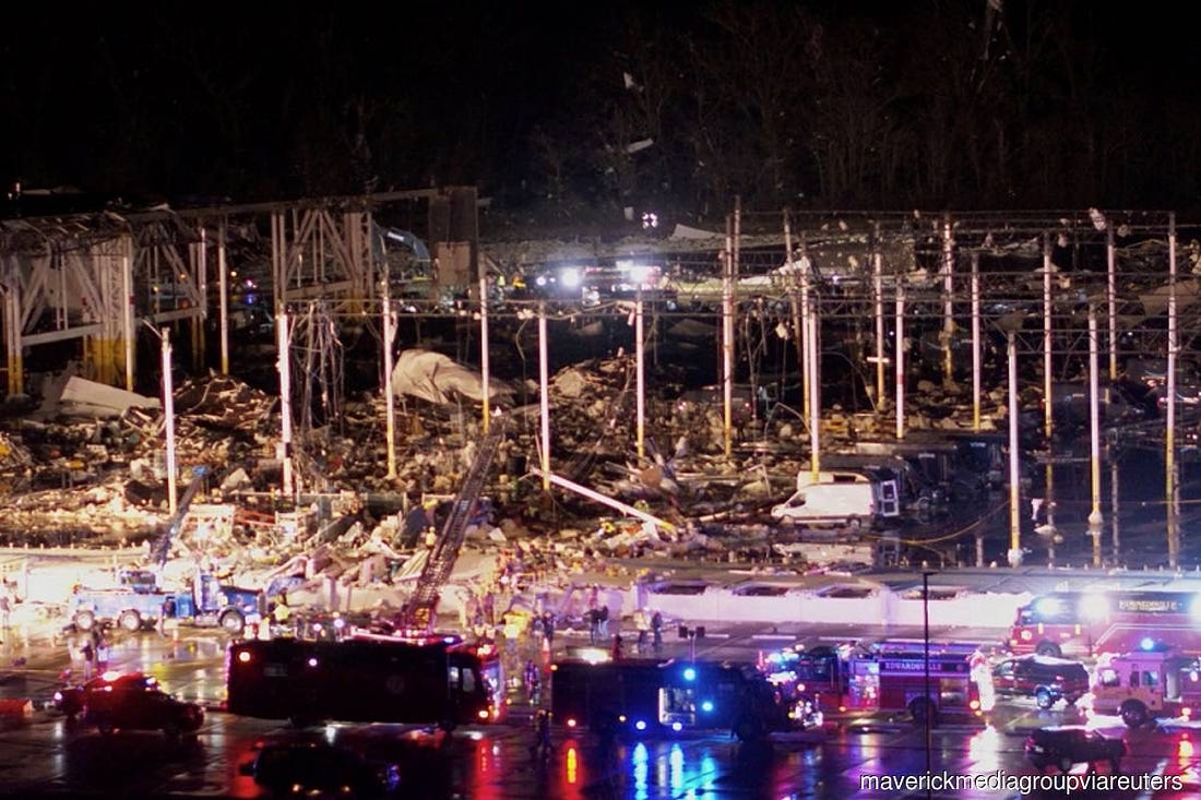 Emergency crews respond at a damaged Amazon.com, Inc warehouse after a tornado passed through Edwardsville, Ill on Friday Dec 10, 2021. (Photo by Chris Phillips/Maverick Media Group via Reuters)