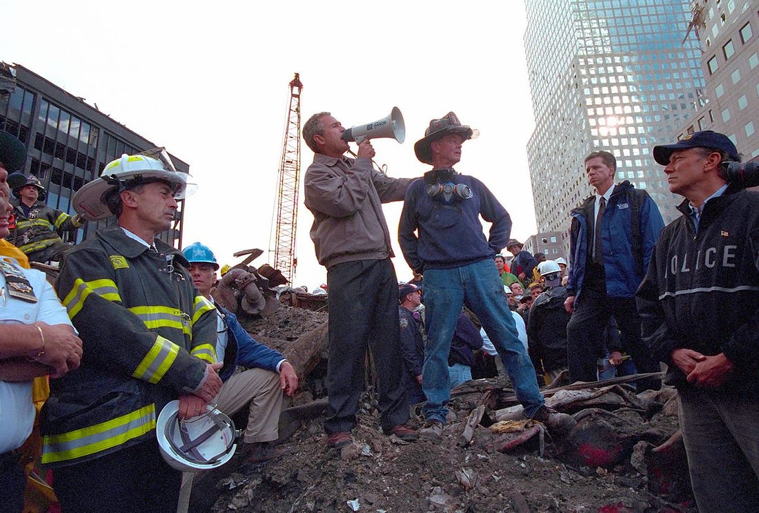 Standing atop rubble with retired New York City firefighter Bob Beckwith, President George W Bush rallies firefighters and rescue workers during an impromptu speech at the site of the collapsed World Trade Center in New York City, New York, September 14, 2001. Image courtesy National Archives. (Smith Collection/Gado/Getty Images)