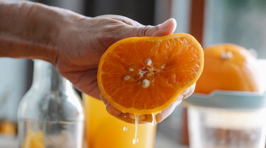 Squeezing juice from an orange