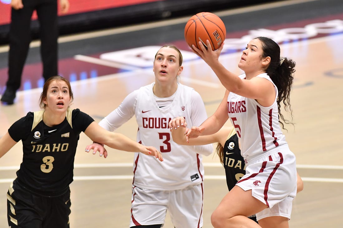 Washington State women's basketball player Charlisse Leger-Walker lays the ball up to score