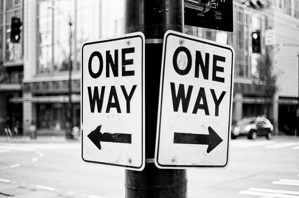 2 one-way signs point at opposite directions