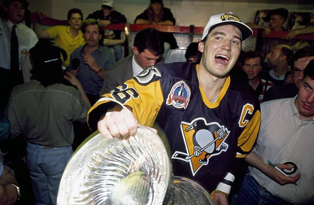 Pittsburgh Penguins Mario Lemieux victorious in locker room with Stanley Cup trophy after winning game and series vs Chicago Blackhawks at Chicago...