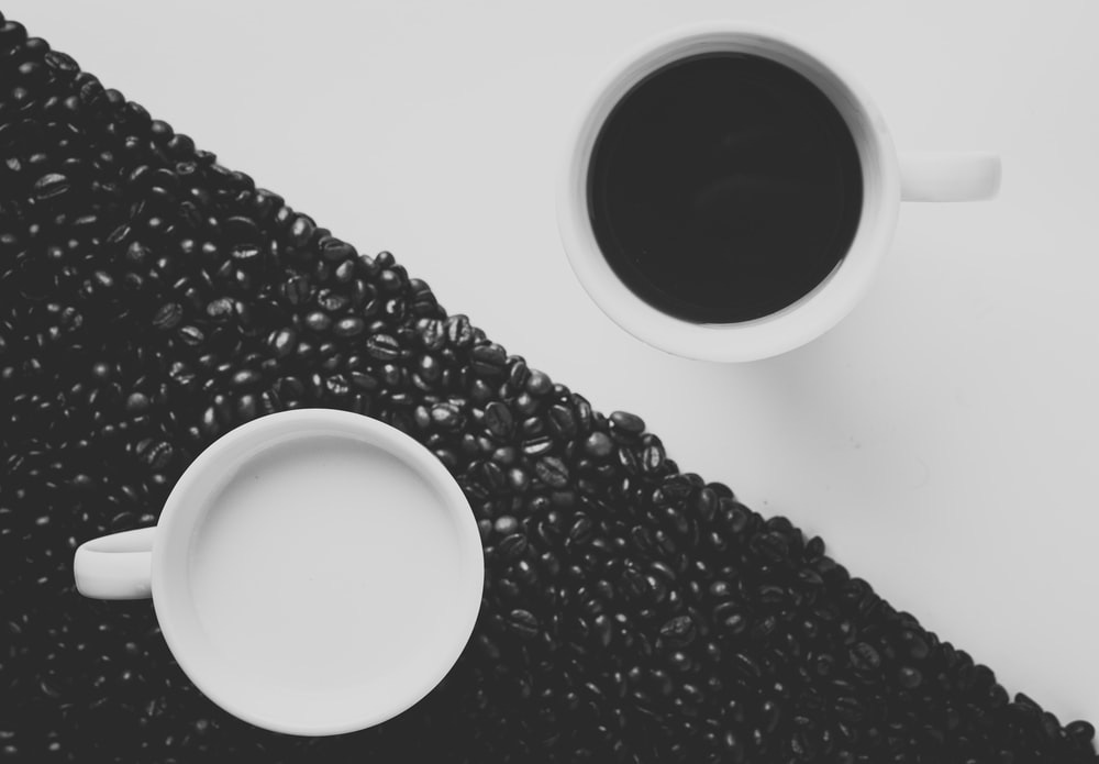 white ceramic coffee mug filled with black liquid
