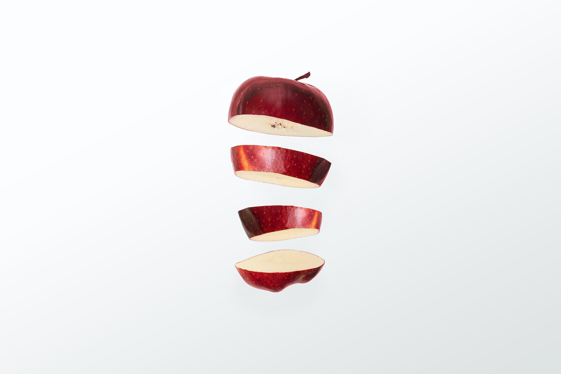 Photo of an Apple in slices. By Nikolai Chernichenko / Unsplash