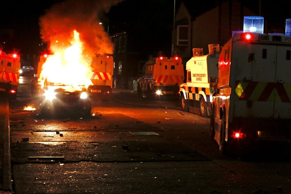 Flames and smoke rise from car set a fire during protests as rioters hurled petrol bombs, fireworks and stones at police amid unrest since Wednesday, in Belfast, Northern Ireland on April 09, 2021. â¨The unrest started when some Sinn Fein members attended a crowded funeral on top of tensions caused by Brexit border arrangements, which brought checks on goods shipped between Northern Ireland and the rest of the UK. â¨Both loyalist and nationalist areas were involved in riots in west Belfast. (Photo by Hasan Esen/Anadolu Agency via Getty Images)