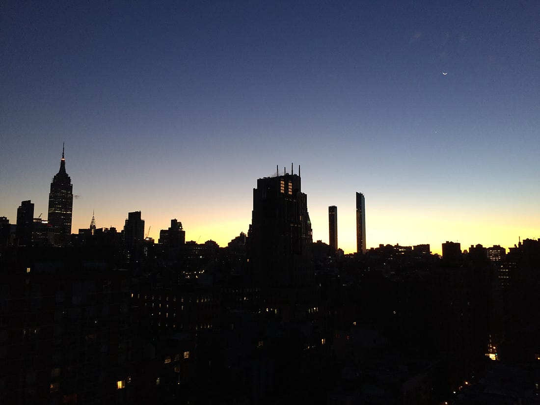 The sun rising across the skyline of New York.