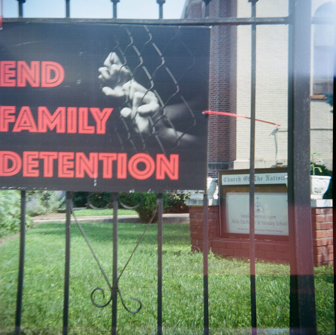 A sign that says "End Family Detention" on the fence at the Church of the Nativity in Flatbush, Brooklyn