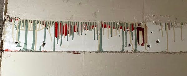 paint drips showing layers of paint in different colors used over the years