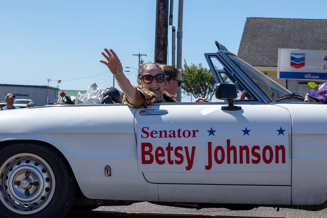 May be an image of one or more people, people standing, car, outdoors and text that says 'Senator Betsy Johnson'