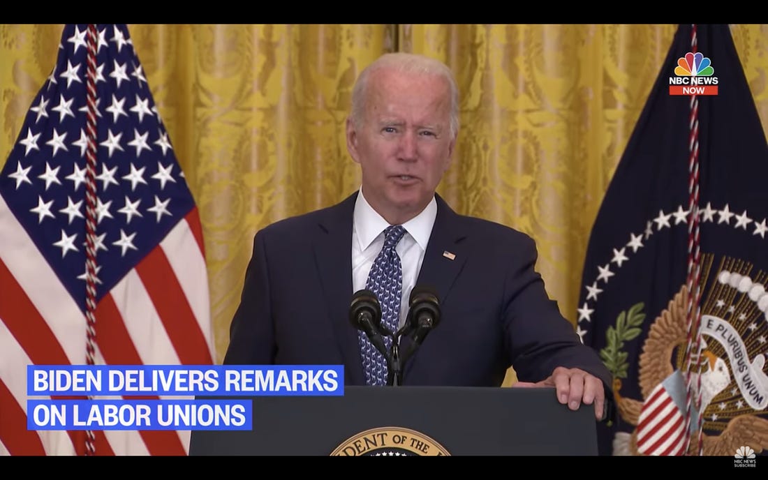 a screenshot of Joe Biden at a presidential podium in front of a US flag and Washington, D.C., flag speaking into a microphone