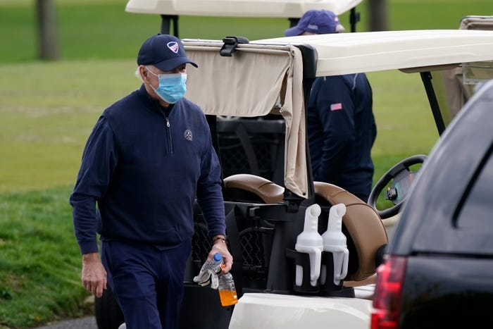 President Joe Biden walks to a motorcade vehicle after golfing at Wilmington Country Club, Saturday, April 17, 2021, in Wilmington, Delaware. President Joe Biden walks to a motorcade vehicle after golfing at Wilmington Country Club, Saturday, April 17, 2021, in Wilmington, Delaware.
