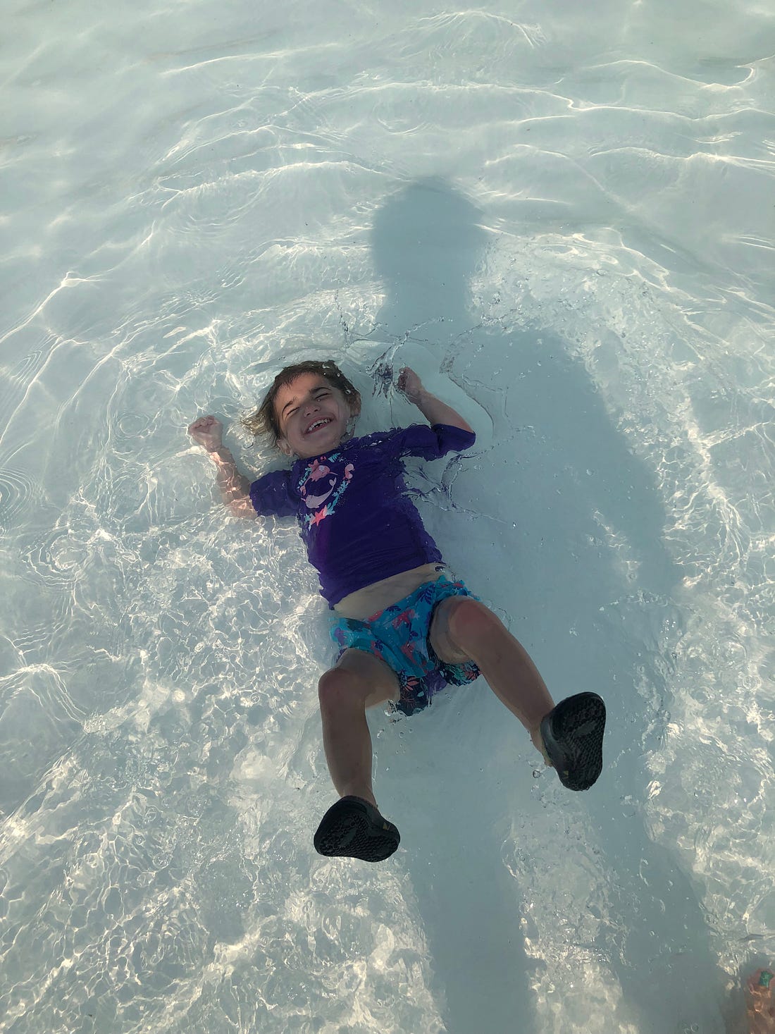 Photograph of a gleeful toddler in a wave pool