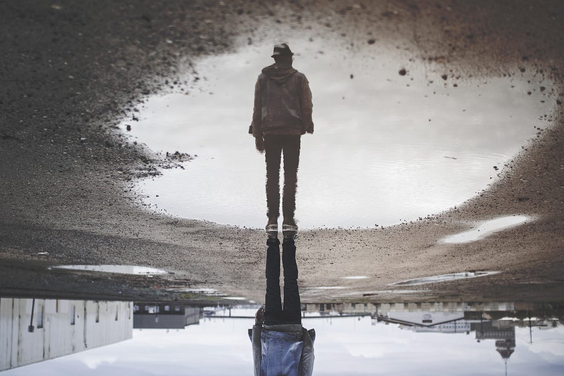 Image of a man’s reflection in a puddle for article by Larry G. Maguire Image of a man’s reflection in a puddle for article by Larry G. Maguire