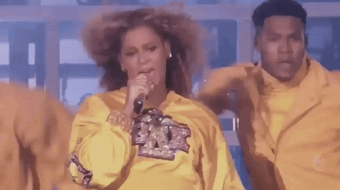 Beyonce dancing in yellow sweatshirt, singing "I know you care!" 