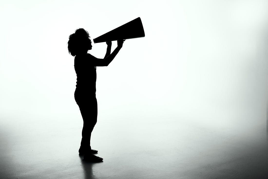 silhouette of someone shouting into a megaphone
