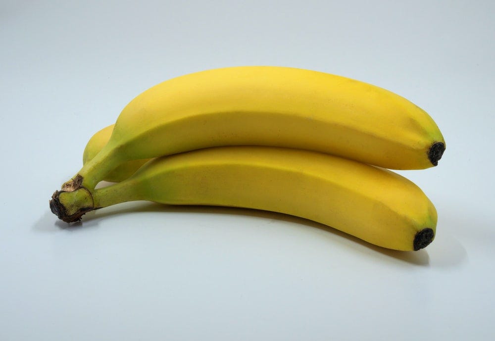three banana fruits on white background