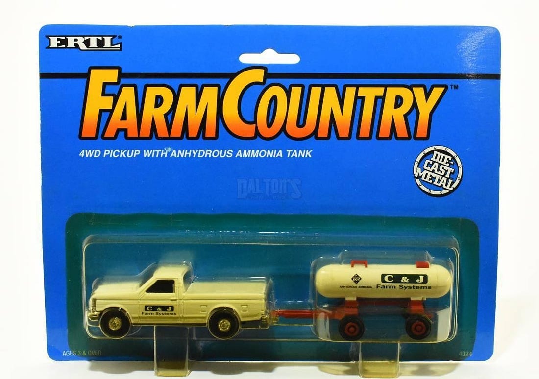 A "Farm Country" branded toy of a four wheel drive pick-up truck hauling a tank of anhydrous ammonia gas