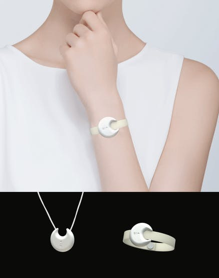 A moonshaped device around a women's wrist and around her neck
