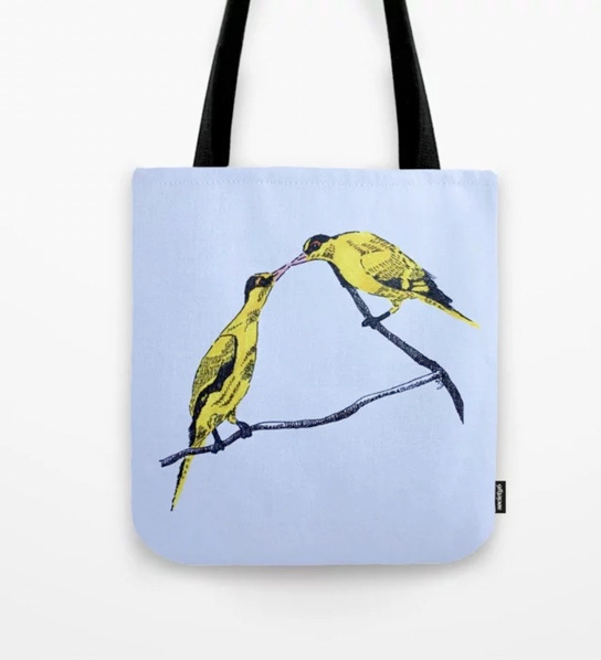photo of Commitment art on a tote bag. Two bright yellow black-naked oriole birds perched on a branch, with their beaks touching, like kissing