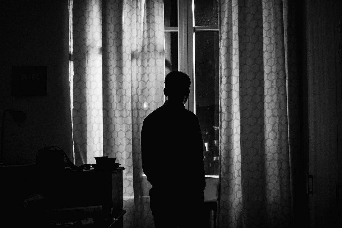 silhouette of person standing inside room