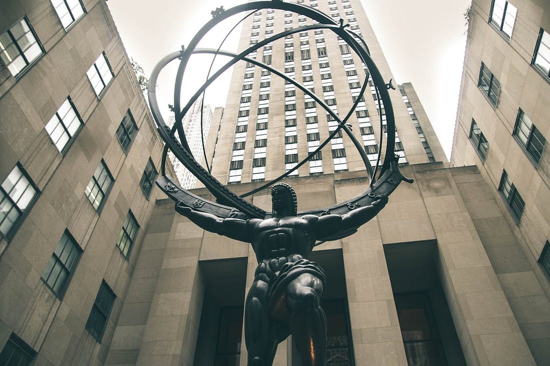 Low-angle Photography of Atlas Statue