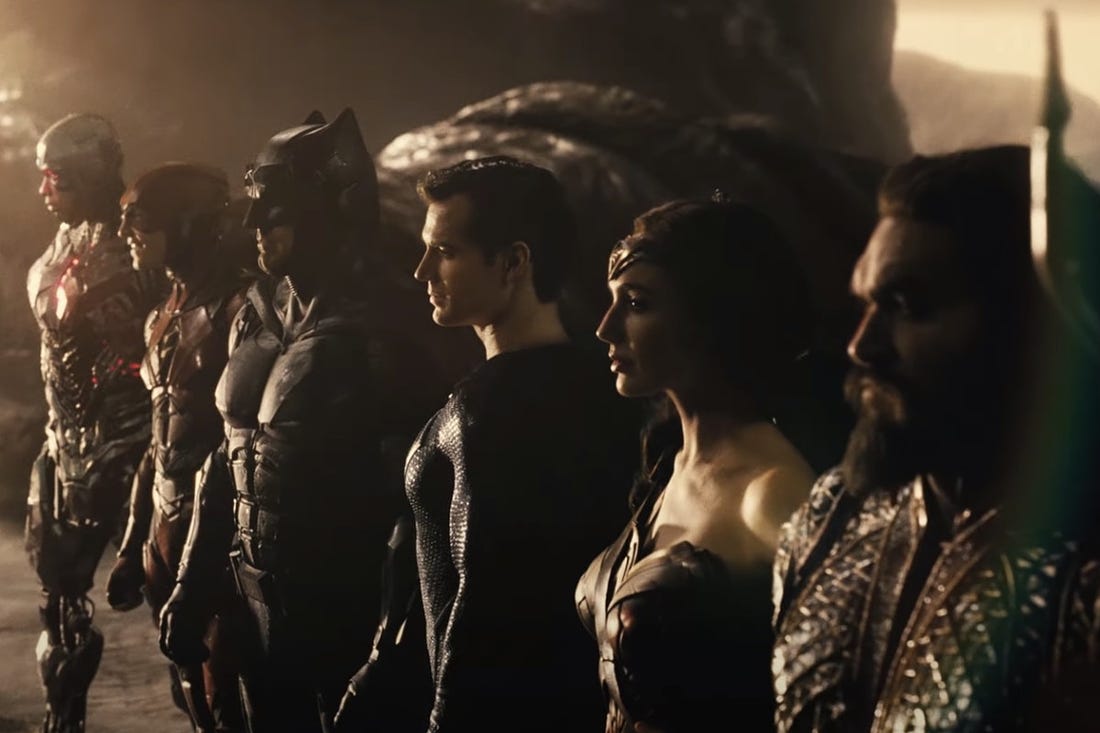 From 'Zack Snyder's Justice League, right to left: Aquaman, WonderWoman, Superman, Batman, The Flash, and Cyborg. They stand united, looking off into the distance, after a victory.