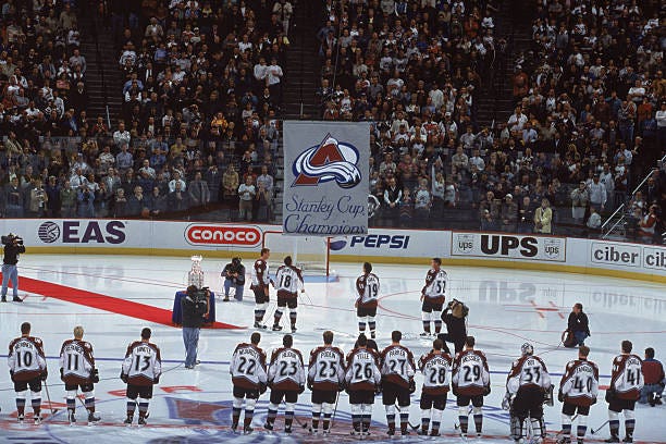 The Colorado Avalanche stand on the ice as they watch unveiling of the Stanley Cup Banner before the game against the Vancouver Canucks at the Pepsi...