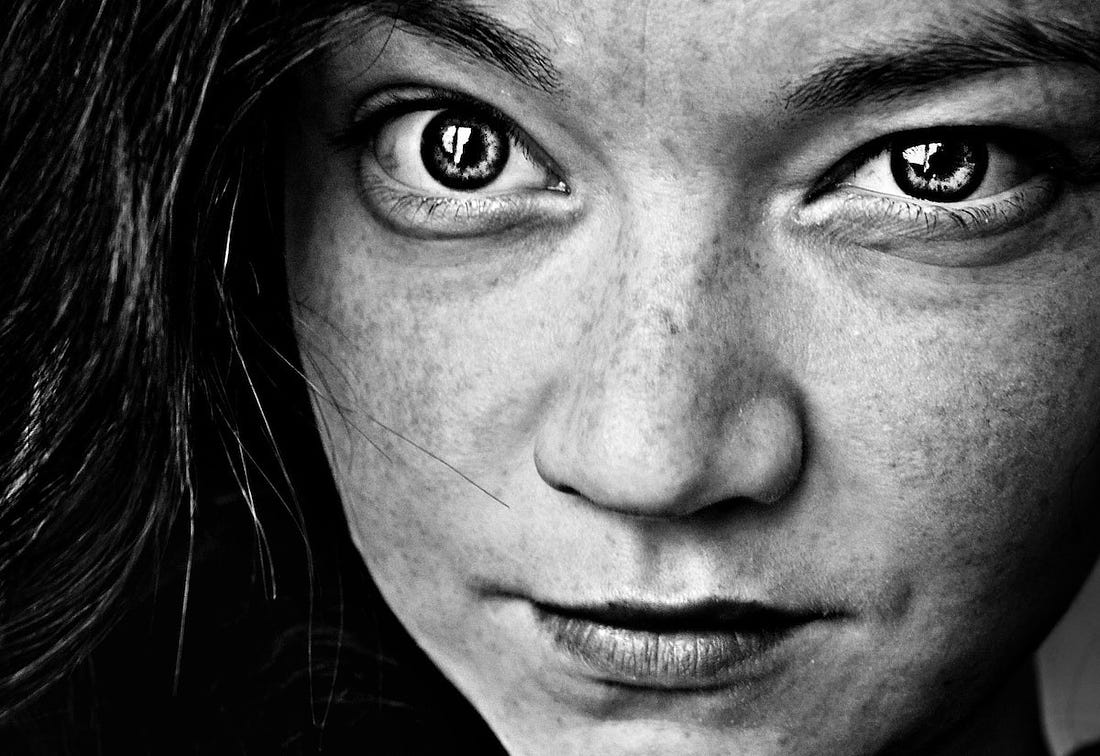 black and white photo of a girl’s face for article by Larry G. Maguire