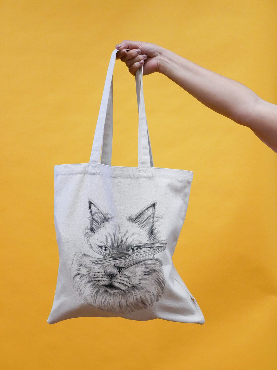 New tee and tote from Henri, which features a very fine pen drawing of a warped cat's face