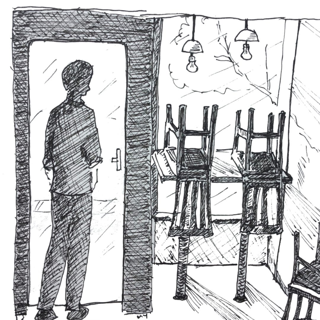 Black and white ink drawing (line drawing) showing a silhouette of a man, inside an empty restaurant. He’s standing in front of his restaurant’s door, head and shoulder drooping down, looking lost. On his right, there’s a counter table overlooking the restaurant window. On the table, there’s are two upturned chairs. There are two nice-looking pendant lamp hanging from the ceiling, on top of the counter table. At the right-hand corner of the drawing, there’s another upturned chair, but seen only partially. The feeling is of loss, sadness, almost bleakness.