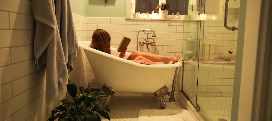 Lady reading in bathtub