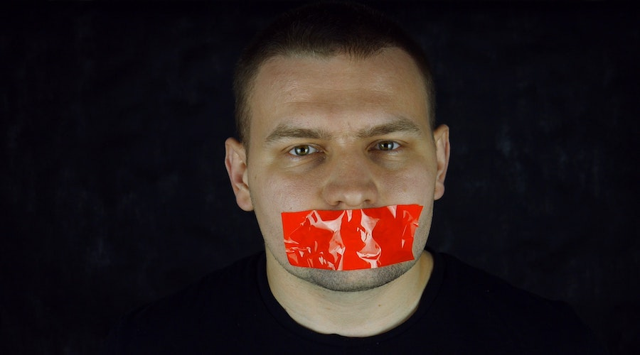 Man with tape over his mouth